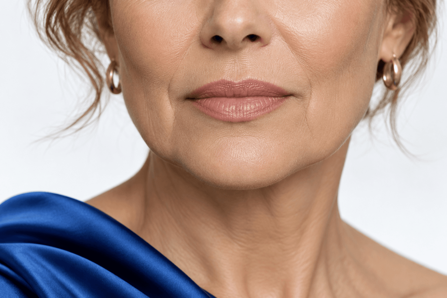 Editorial close-up of a woman’s mouth and chin area.